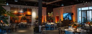 a vibrant, modern event rental showroom in santa rosa, showcasing an array of elegantly styled tables and chairs, adorned with striking centerpieces under ambient lighting, creating an inviting atmosphere for various occasions.
